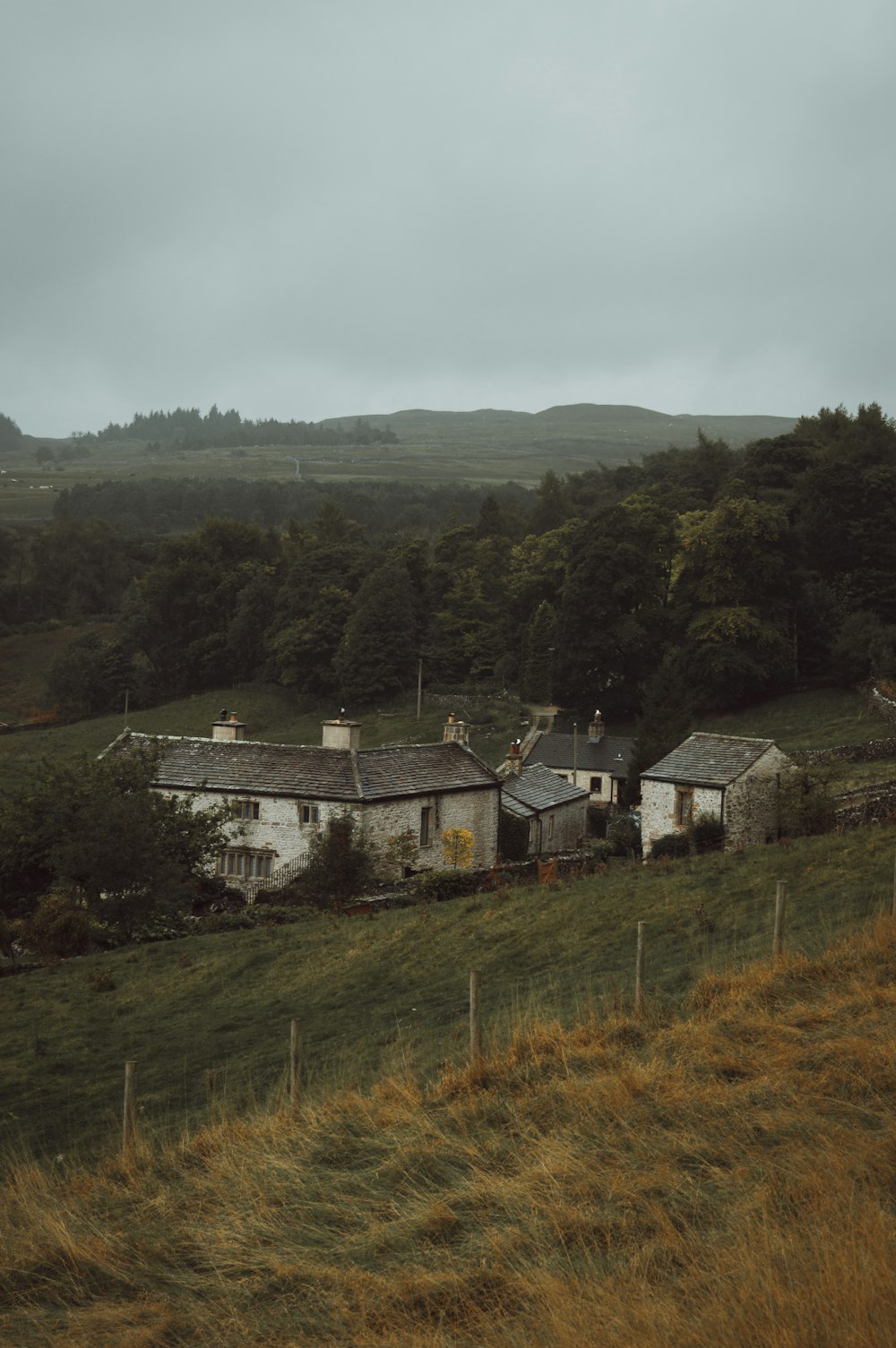 an old farm house in the middle of a field