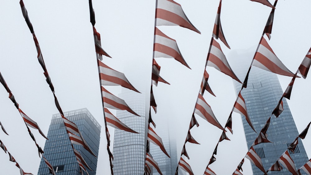 a group of american flags blowing in the wind