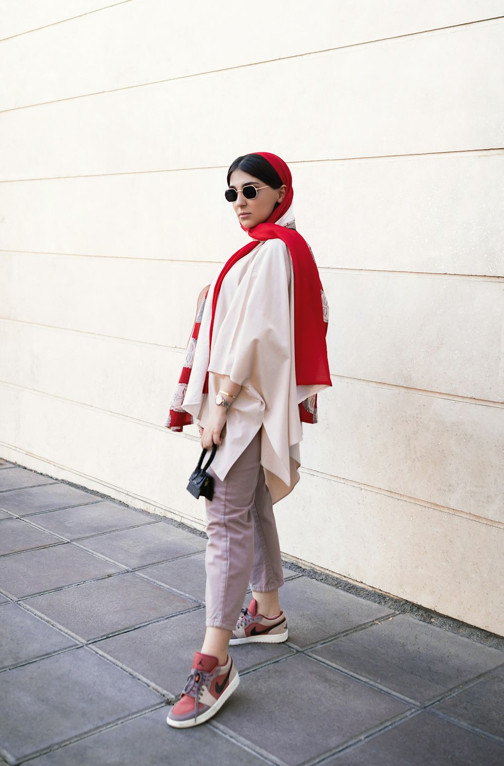 a woman wearing sunglasses and a red scarf