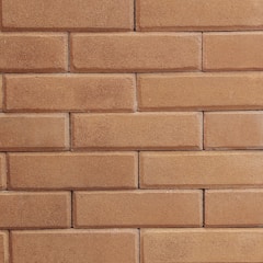 A close-up view of a brick wall constructed with rectangular bricks laid in a horizontal pattern. The bricks have a textured surface with a consistent light brown color.