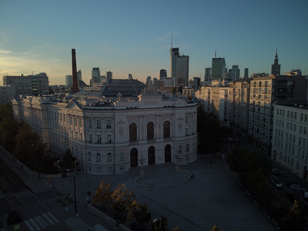 a large white building in the middle of a city