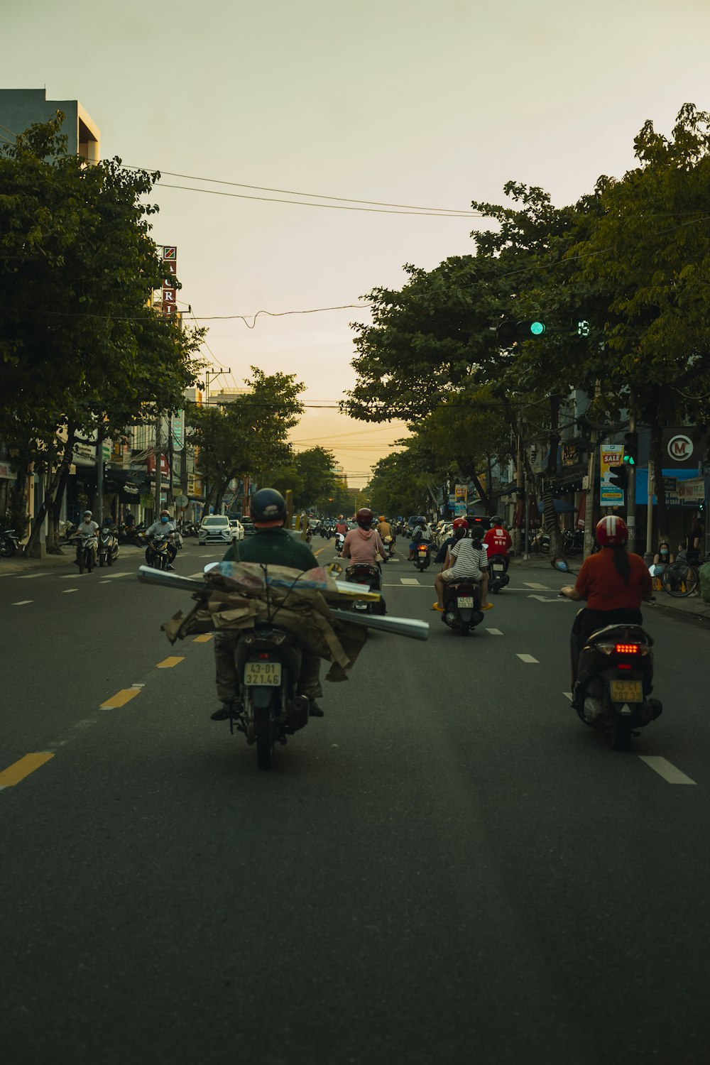 a group of people riding motorcycles down a street