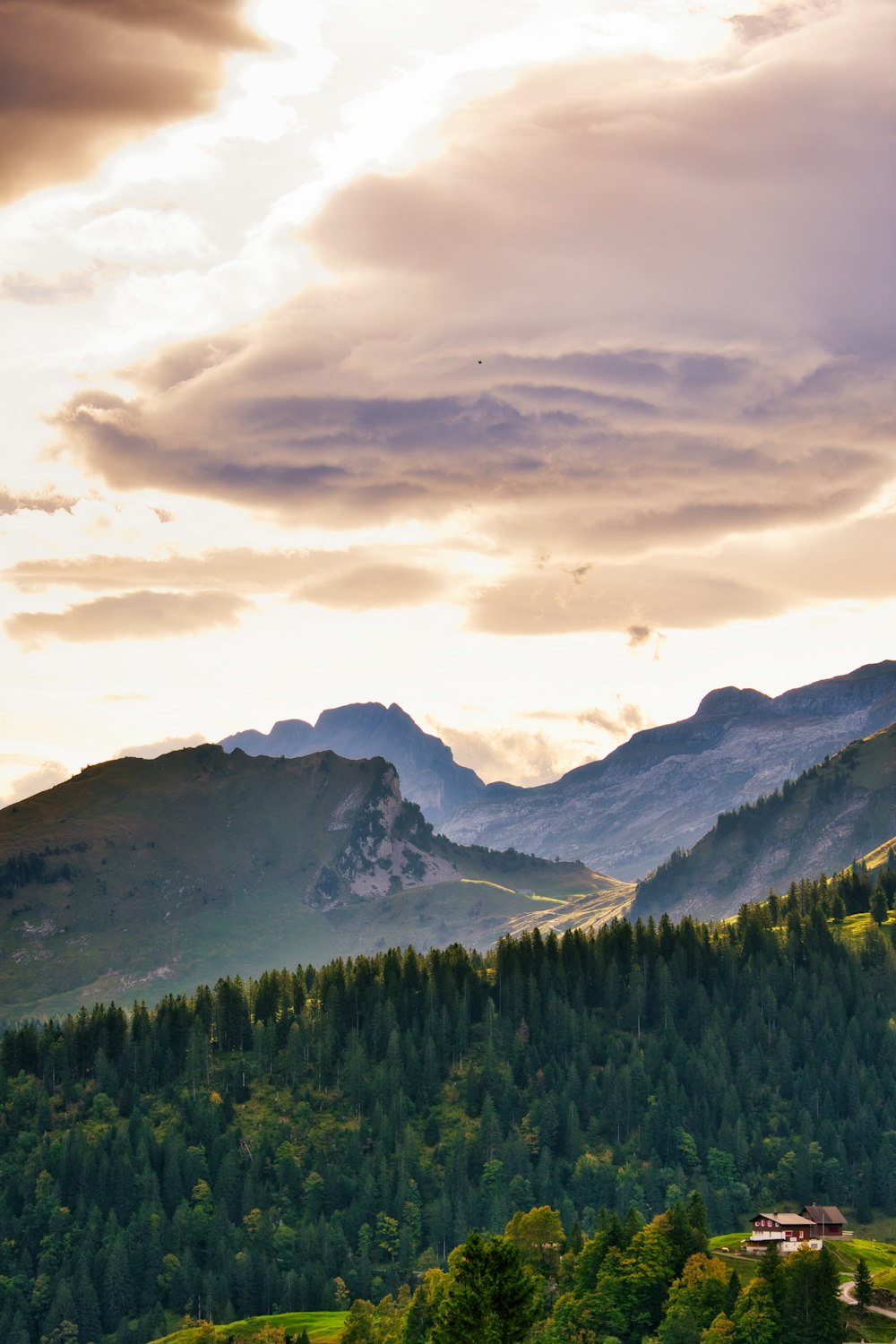 a view of a mountain range with a house in the foreground