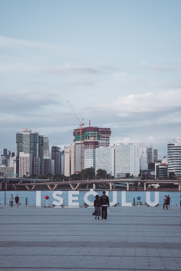 a group of people standing on top of a cement field