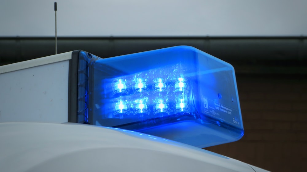 a blue light on top of a white truck