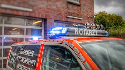 an orange police car parked in front of a building