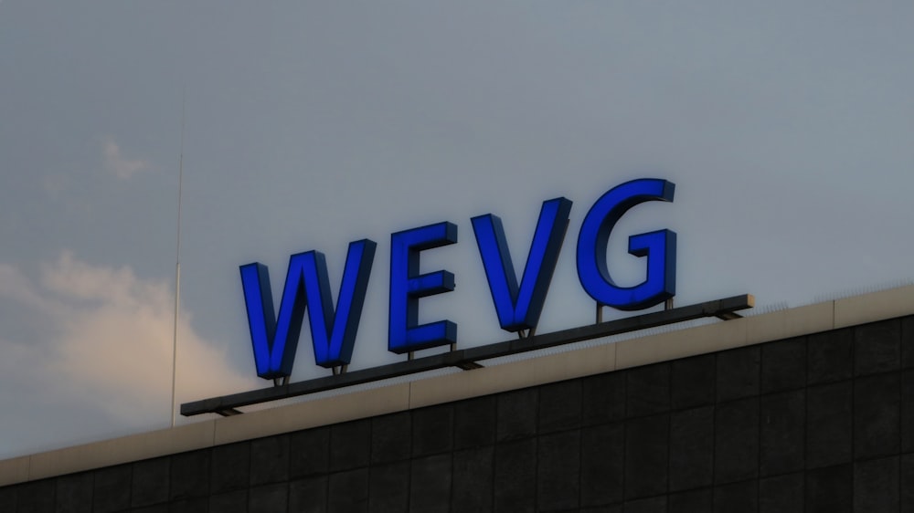 a sign that says wevg on top of a building
