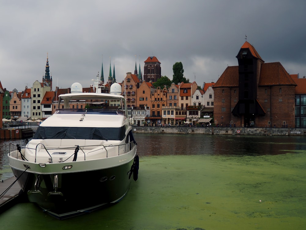 a boat docked at a dock in front of a city