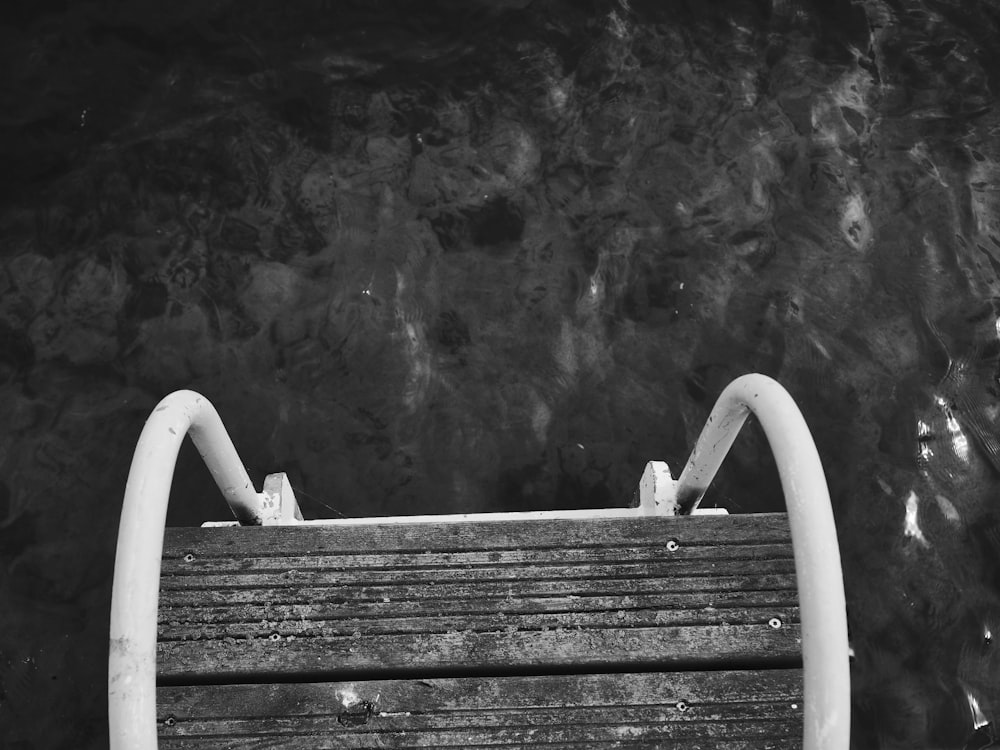 a black and white photo of a wooden bench