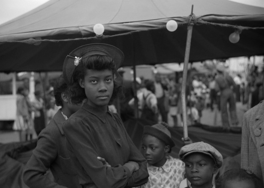 a group of people standing under a tent