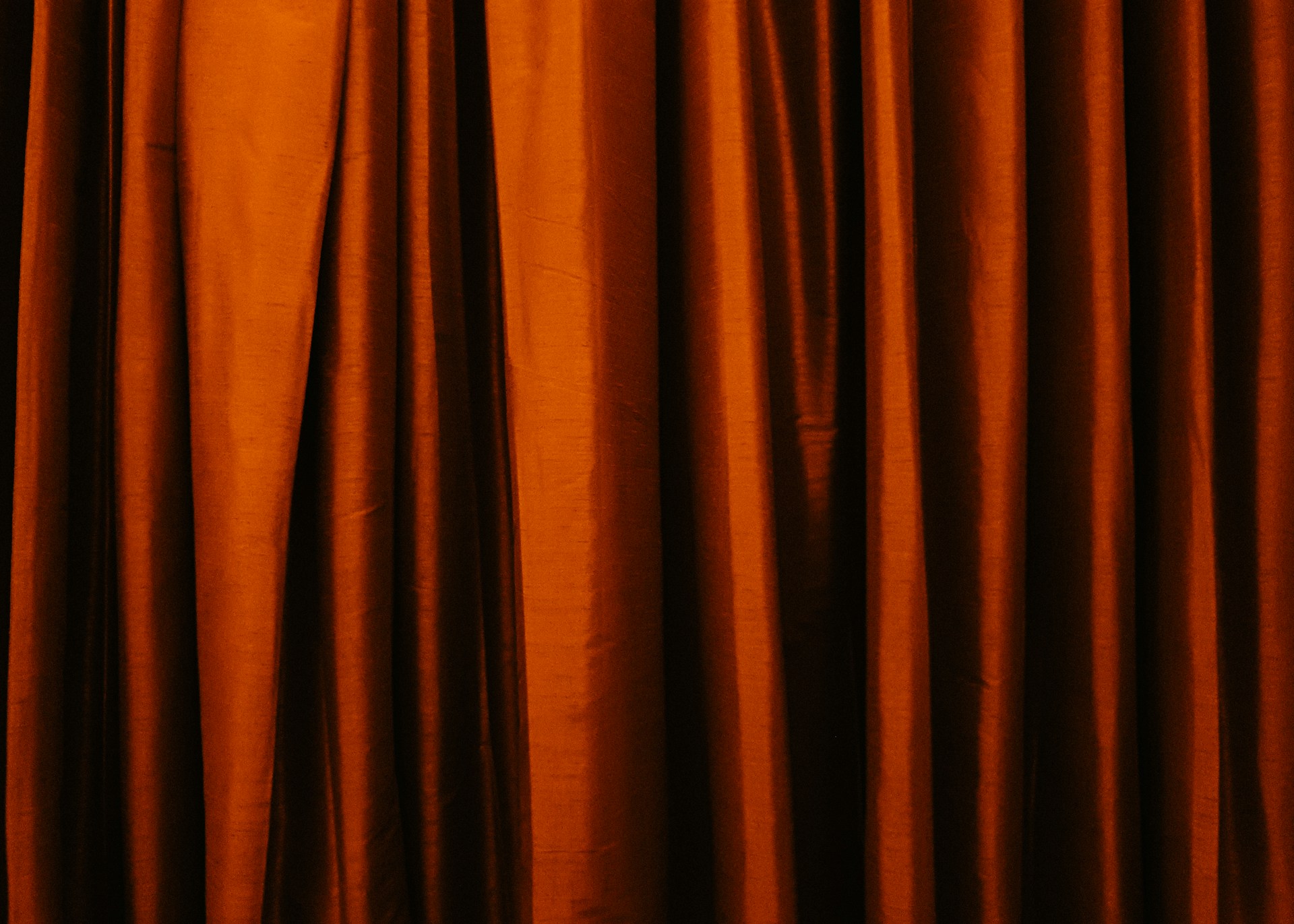 an orange curtain with a black background