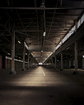 An expansive industrial warehouse with clean lines and bright lighting.