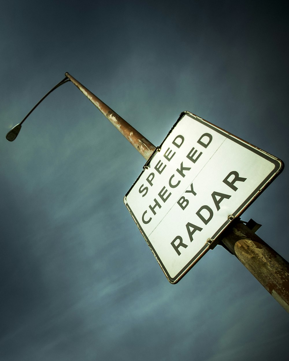 a street sign that reads speed check by raddar