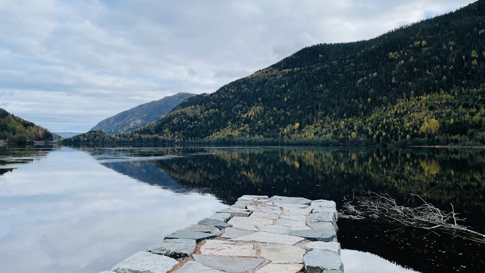 a stone dock sitting on the side of a lake