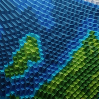 A geometric, isometric art piece composed of 3D cubes arranged in a pattern that mimics a topographical map. The colors transition from blue to green, suggesting water and land formations.