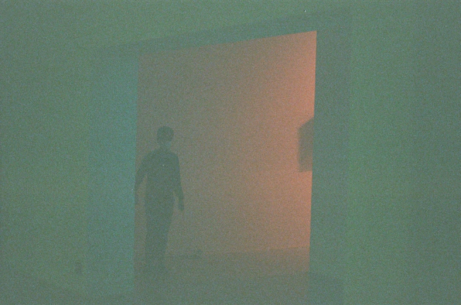 A mysterious figure in silhouette, framed by ambient lighting, inviting curiosity.