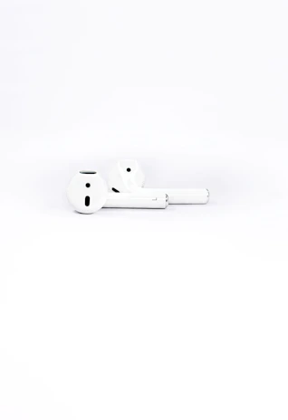 Wireless headphones with a minimalist design placed on a clean white surface.