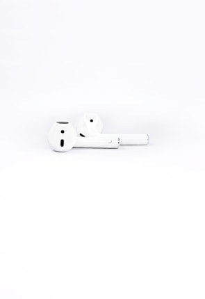 A pair of wireless earbuds displayed against a minimalist white background.