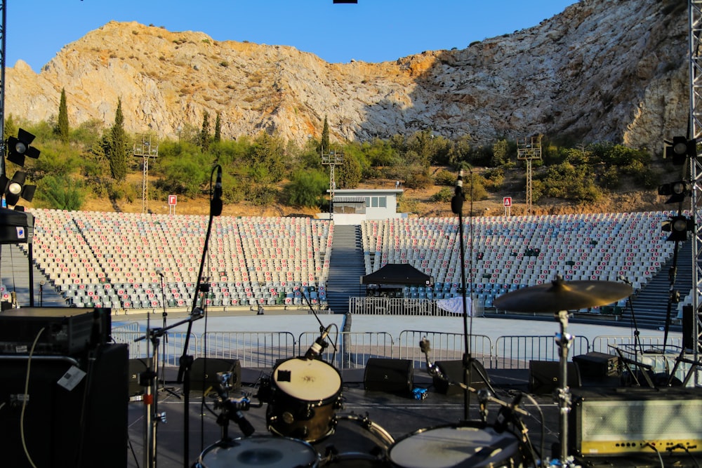 a stage set up for a concert with a mountain in the background