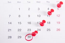 a calendar with red tacks pinned one day per week