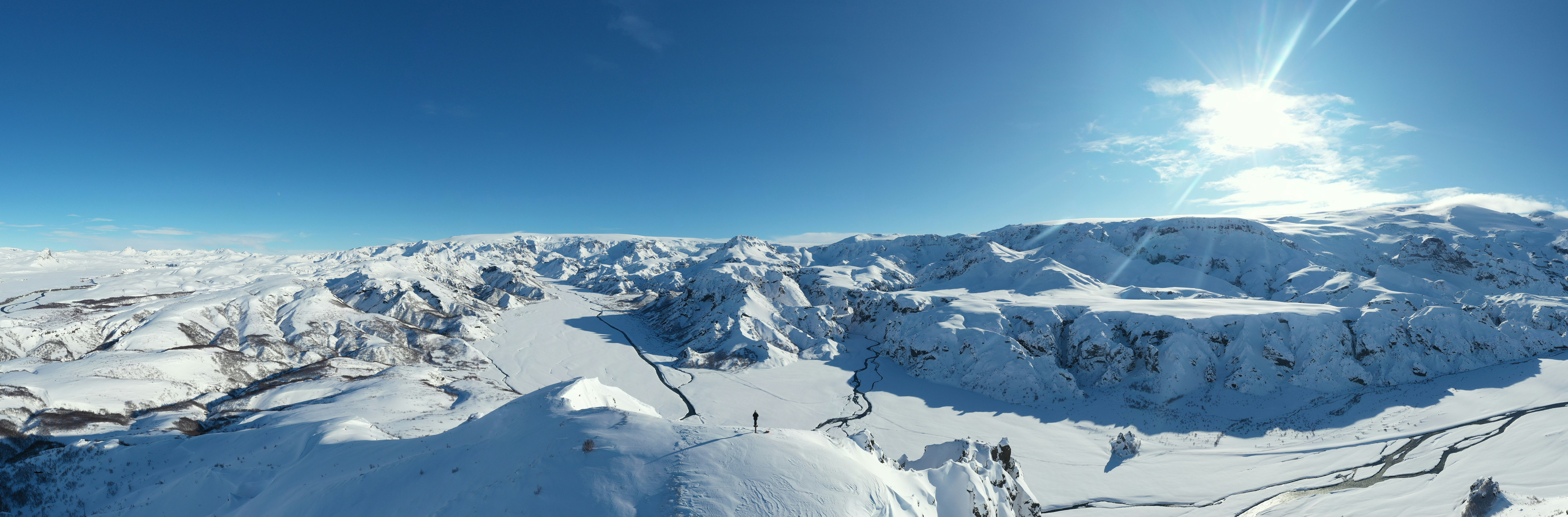 a view of a snowy mountain range from a helicopter