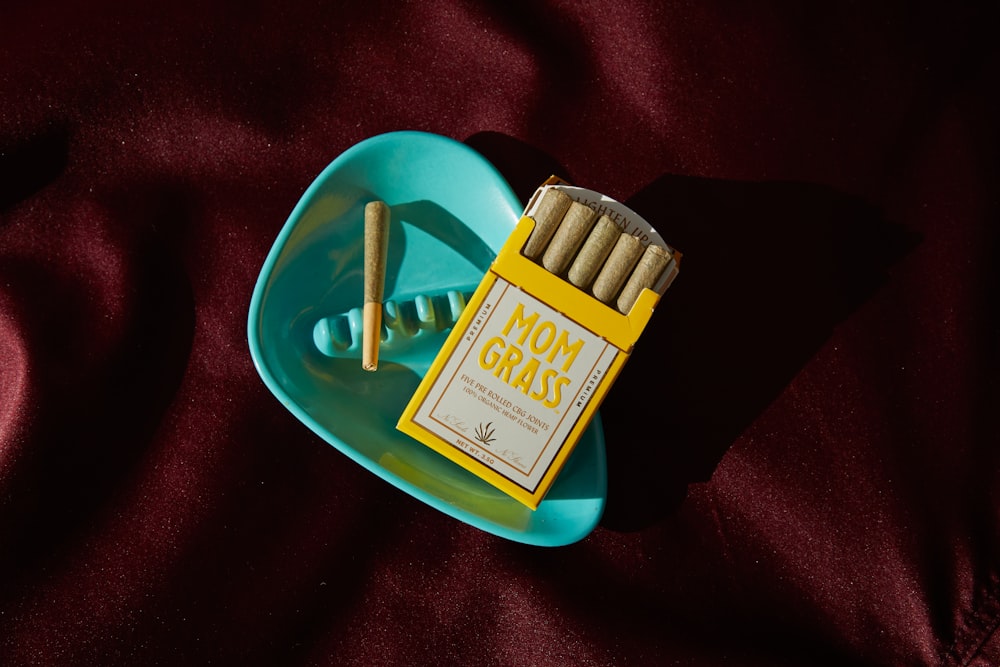 a pack of cigarettes sitting on top of a blue plate