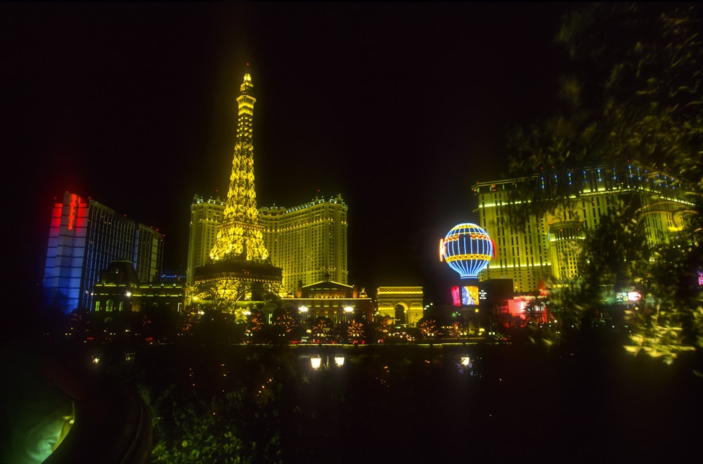 the las vegas strip at night with the eiffel tower lit up