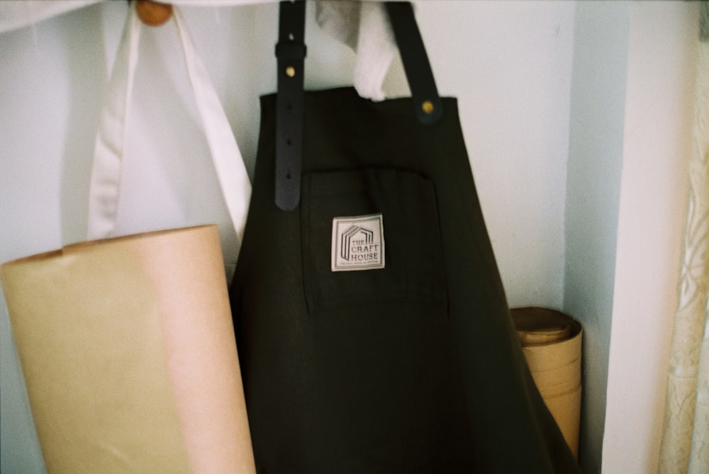 a black bag sitting on top of a shelf next to a lamp