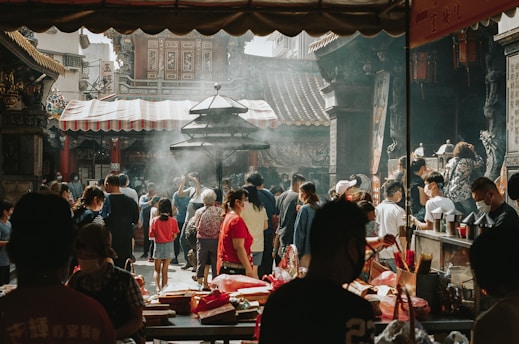 a group of people standing around a market