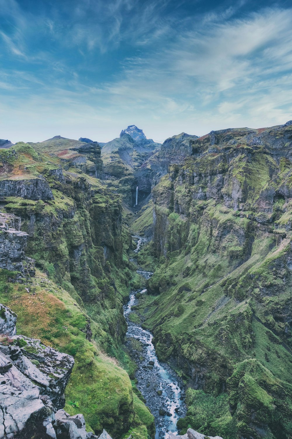 a river flowing through a lush green valley