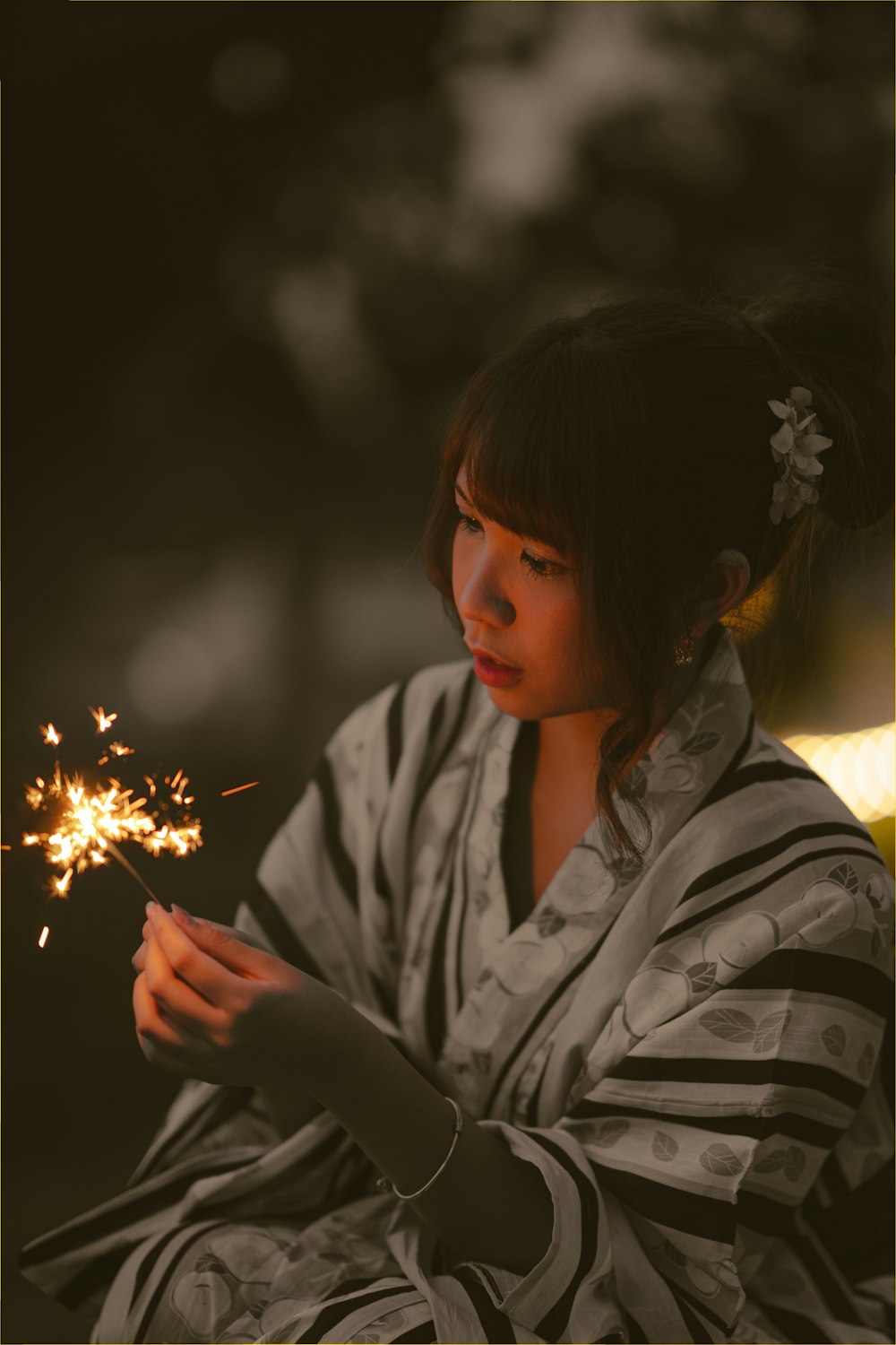 a woman holding a sparkler in her hand