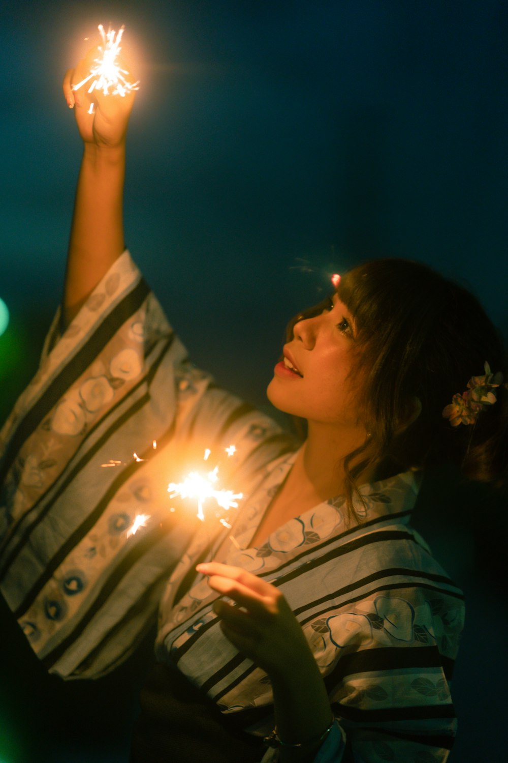 a woman holding a sparkler in her hand