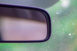 Close-up of an advanced electronic rearview mirror mounted inside a car.
