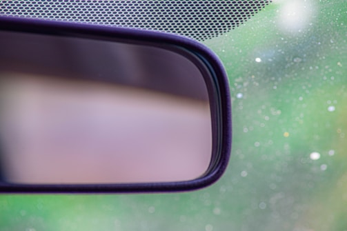 Close-up of an advanced electronic rearview mirror mounted inside a car.