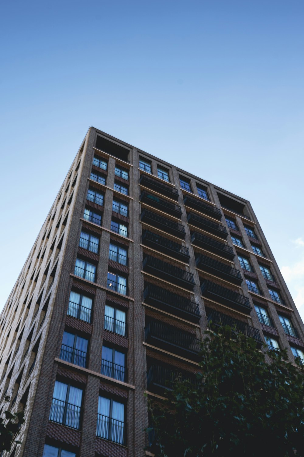 a tall building with lots of windows and balconies