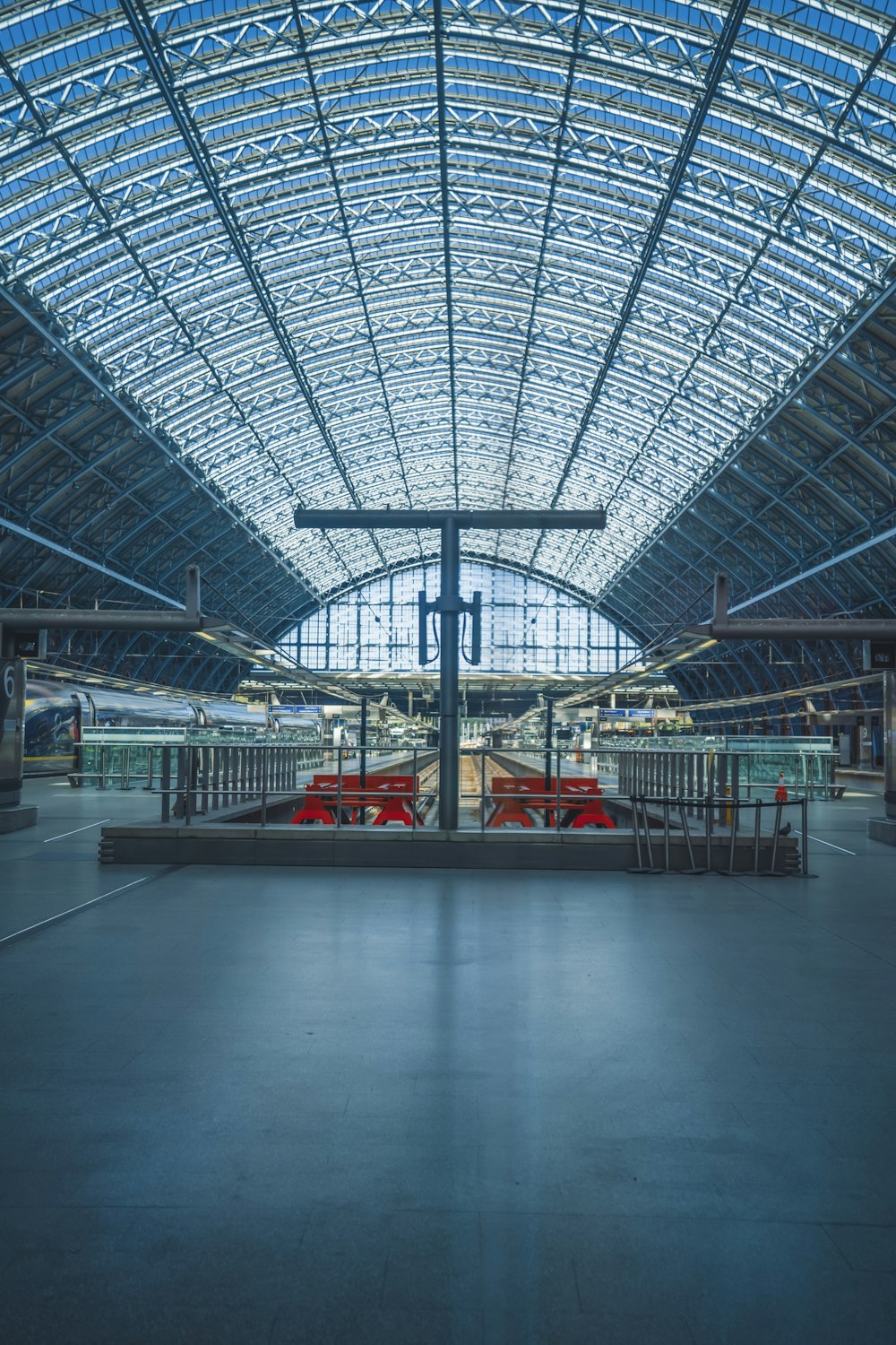 a train station with a large glass ceiling