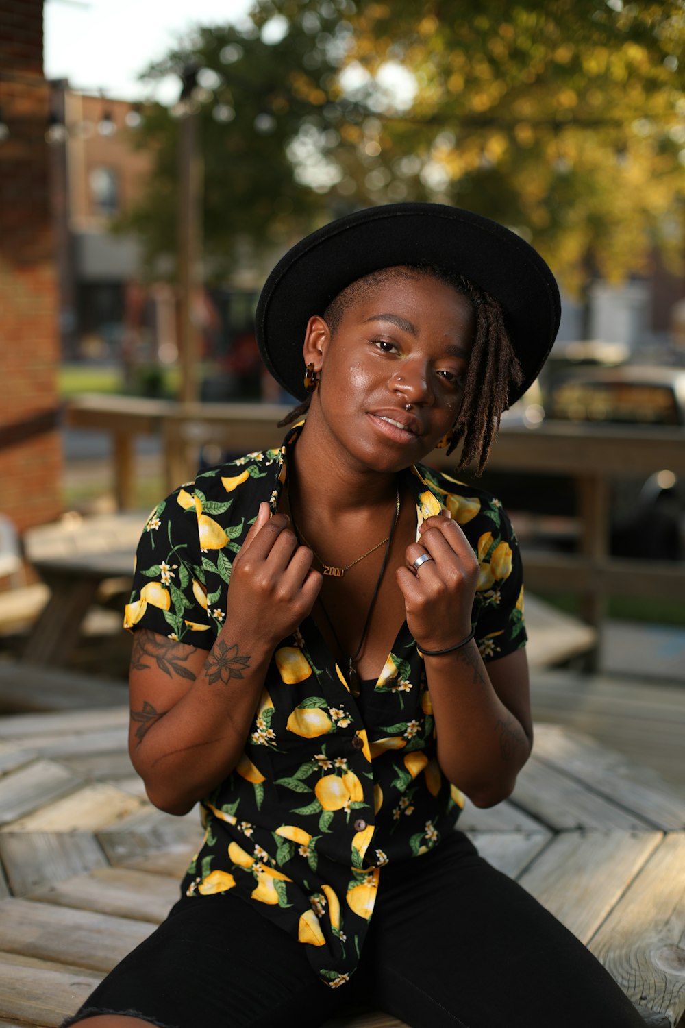 a woman sitting on a bench wearing a hat