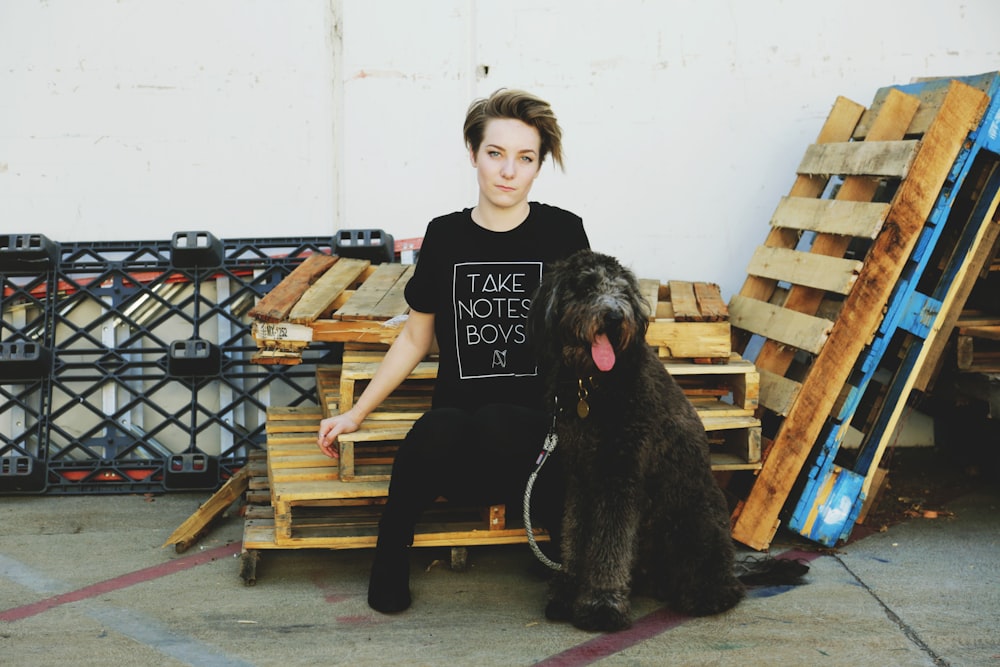 a woman sitting on a bench with a dog