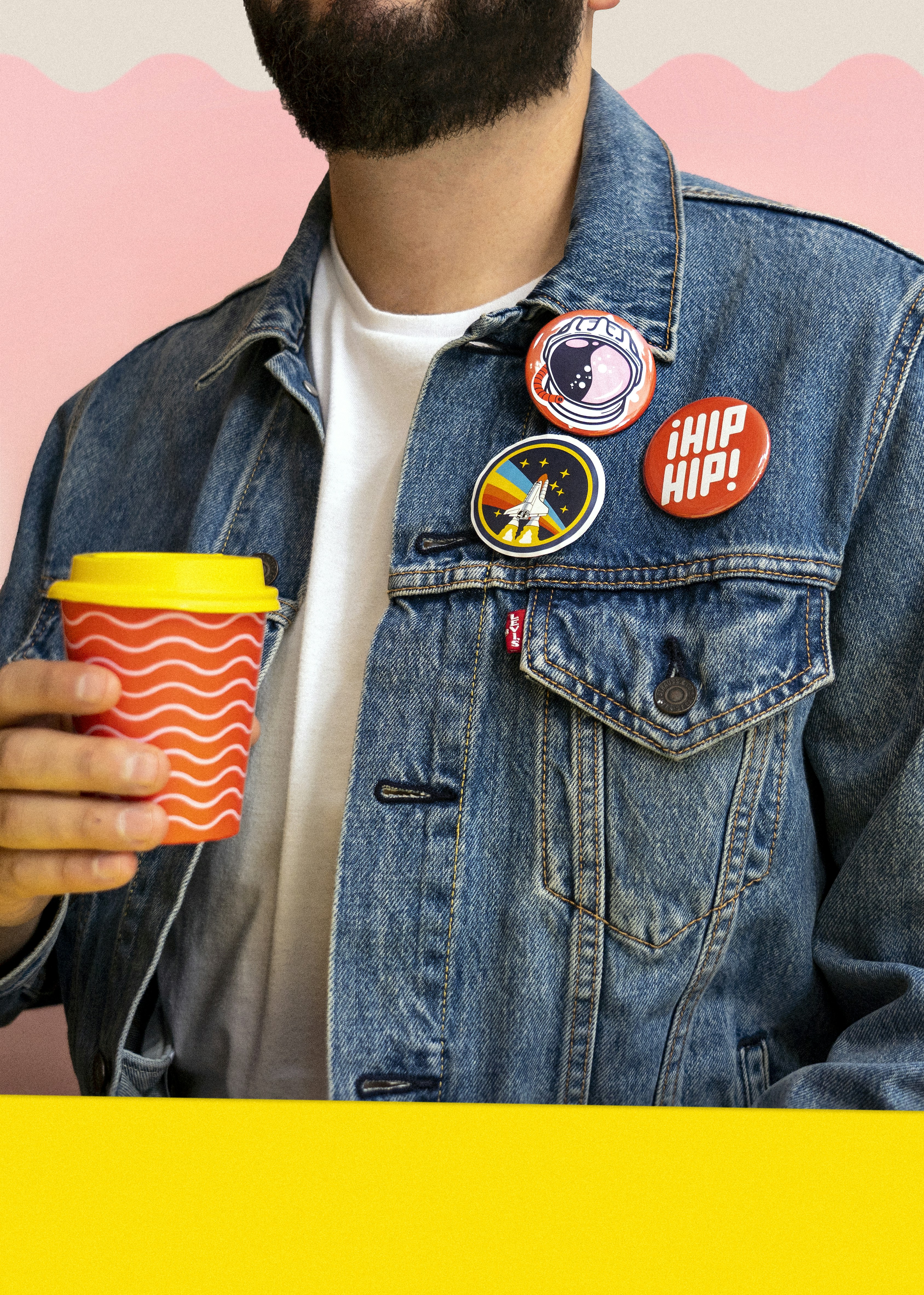 a man with a beard holding a cup of coffee