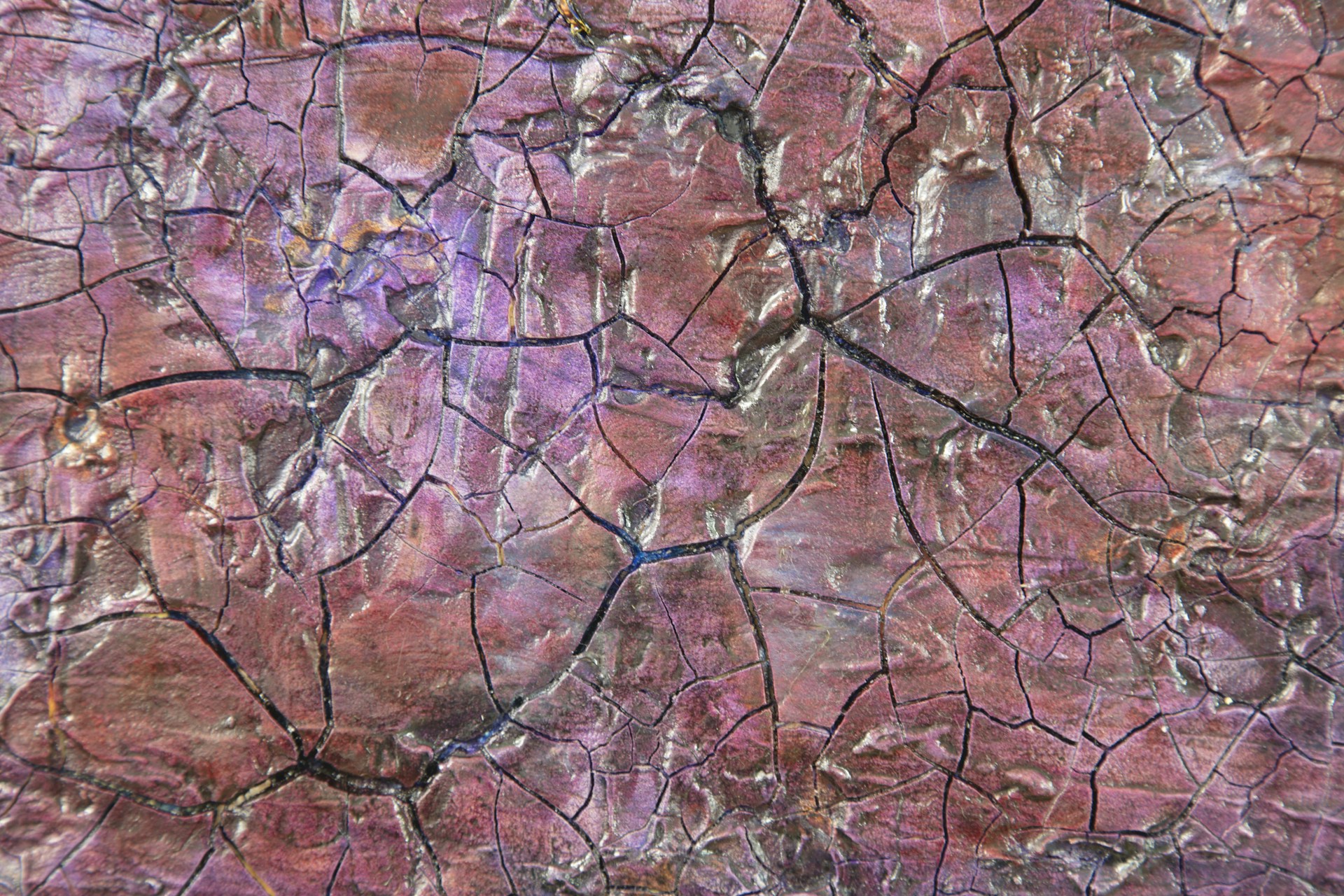 a close up of a rock with cracks in it