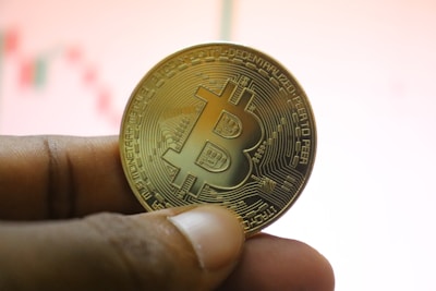 a person holding a bit coin in their hand