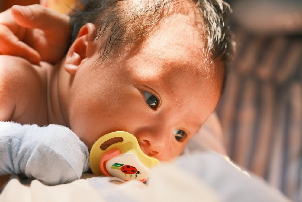 a baby with a pacifier in its mouth