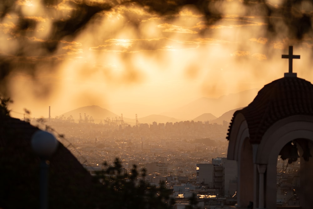 a view of a city with a cross on top of it