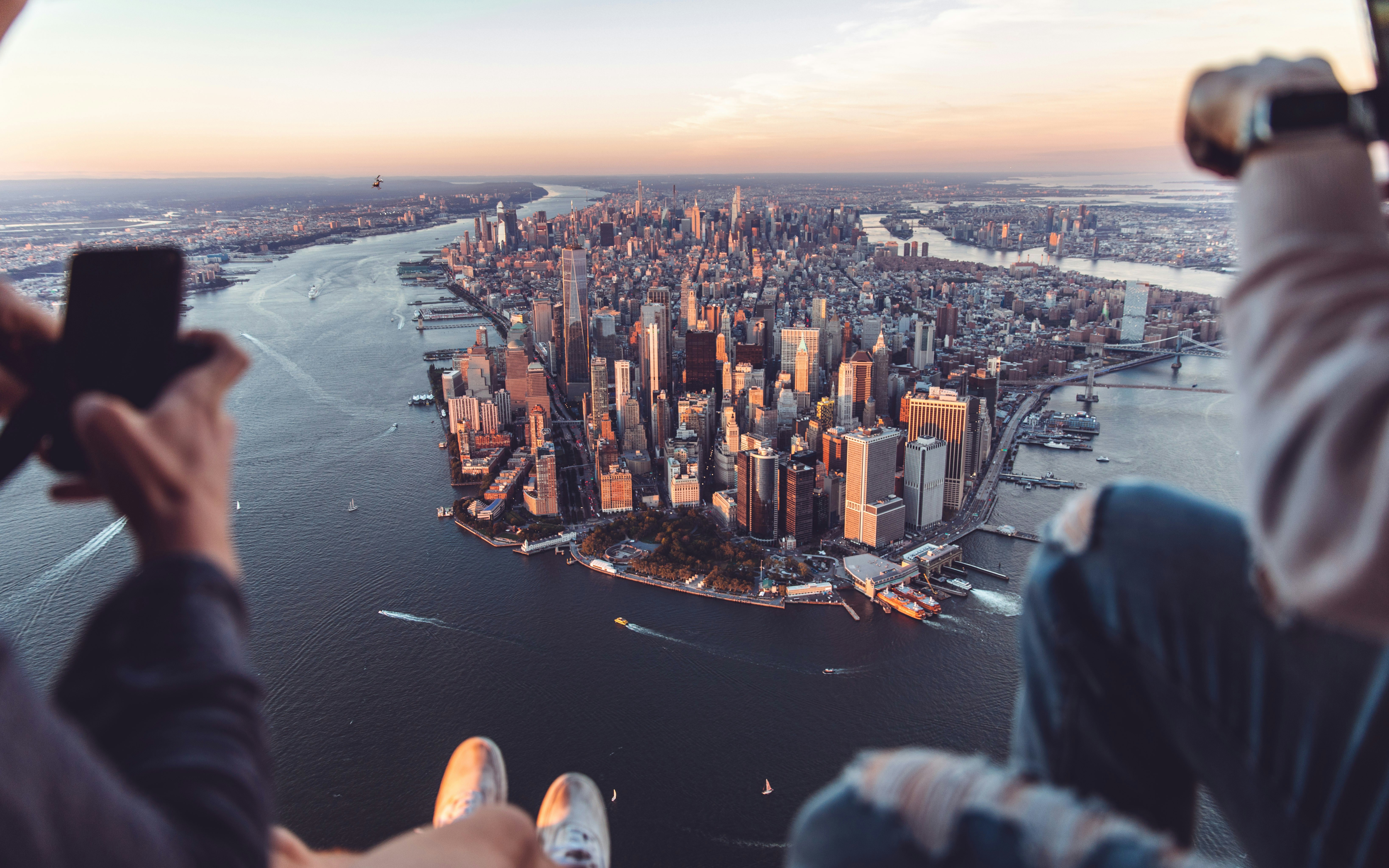 a person taking a picture of a city from a plane