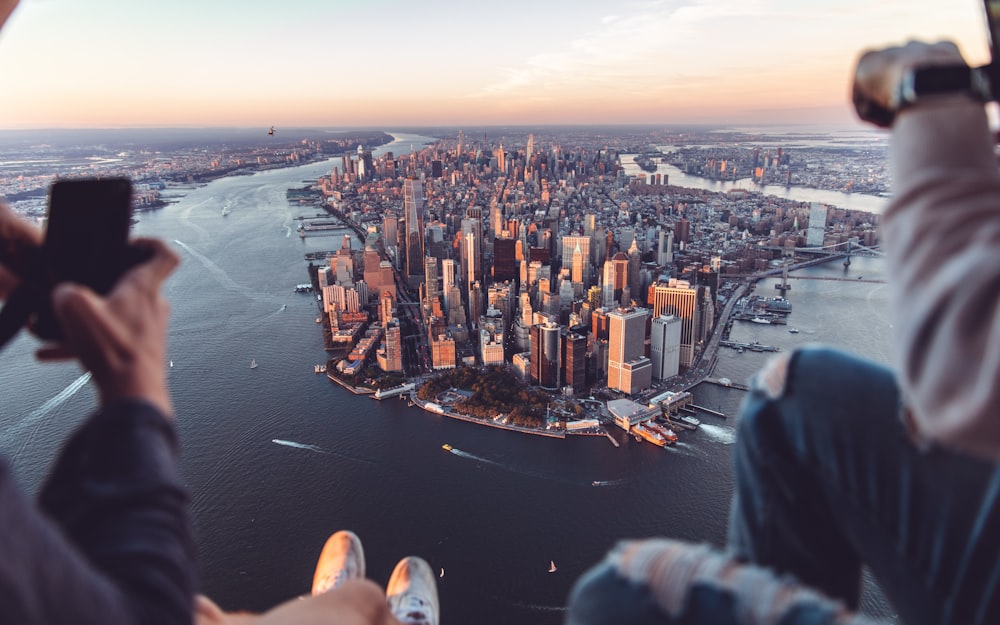 a person taking a picture of a city from a plane