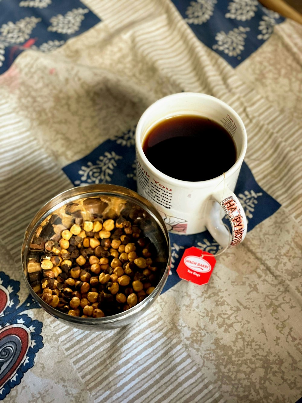 a bowl of food next to a cup of coffee