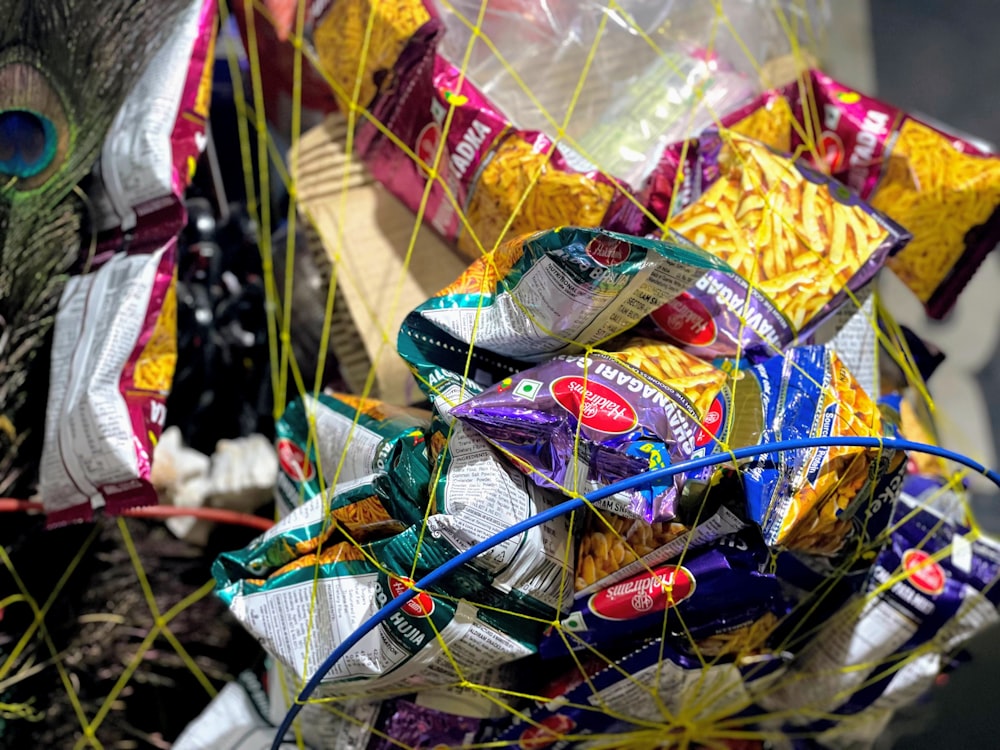 a basket filled with lots of candy sitting on top of a tree