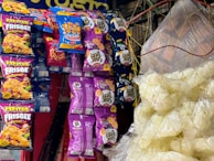 Selection of Swinkels branded snack packs with a cheerful family enjoying snack time.