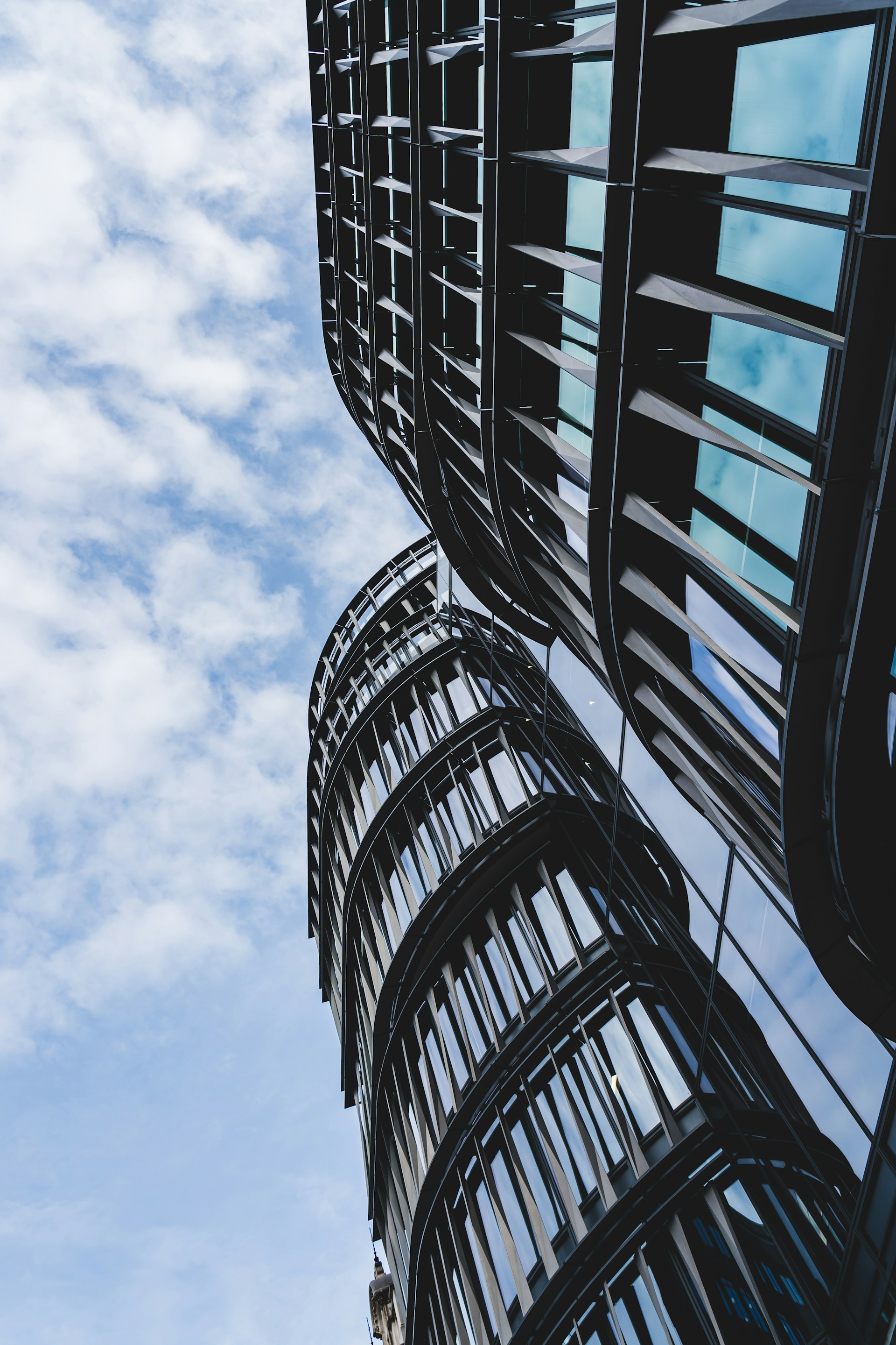 a tall building with many windows and a sky background