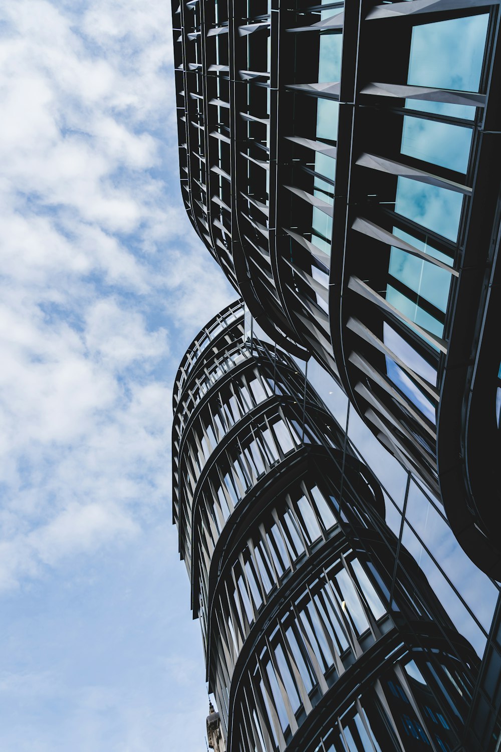 a tall building with many windows and a sky background